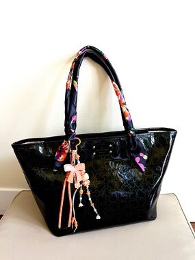 kate spade Black Patent Tote with Floral-Print Handle Wraps and an orange Charm